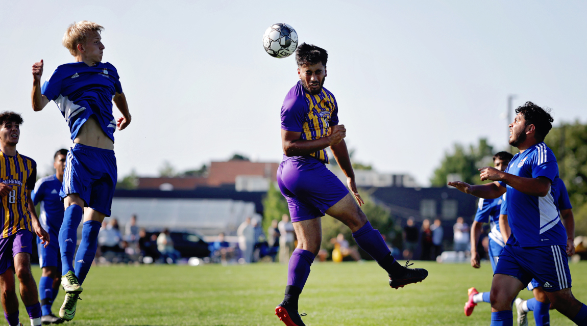 An MCC soccer player leaps in the air and hits the ball with his head.